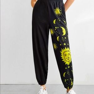 Black sweatpants with sun and moon patterns